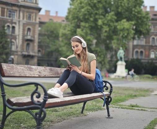 young woman sitting bench reads book 641386 91